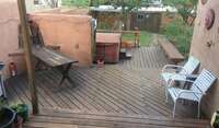 View looking out back door - hot tub, deck, and gardens